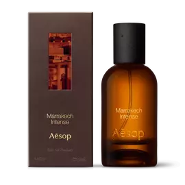 Amber glass Aesop Marrakech Intense Eau de Parfum bottle beside its brown outer box on a white background.