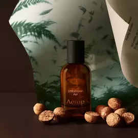 Aesop Unforeseen Aer bottle with whole nutmegs and curved paper.