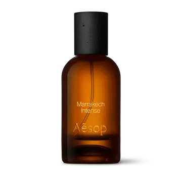 Amber glass Aesop Marrakech Intense Eau de Parfum bottle with black cap on a white background.