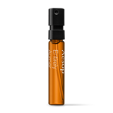 Product sample bottle with black cap on a light background.